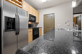 A kitchen with stainless steel appliances and granite counter tops
